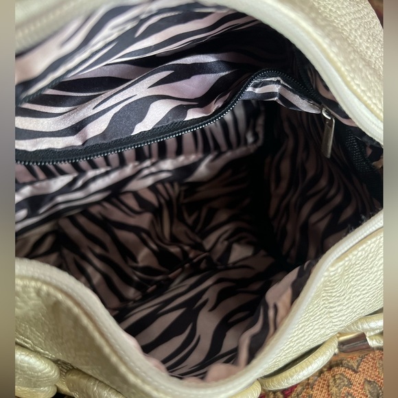 unique design with embossed circular details and a structured, metallic handle. - Picture 12 of 12